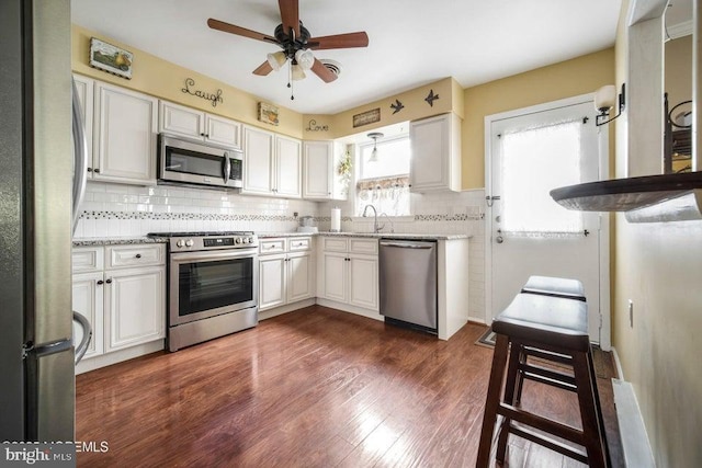 17 Drake St Unit 54A, Whiting, NJ 08759 - kitchen featuring stainless steel appliances, tasteful backsplash, ceiling fan, dark wood-style floors, and light stone countertops
