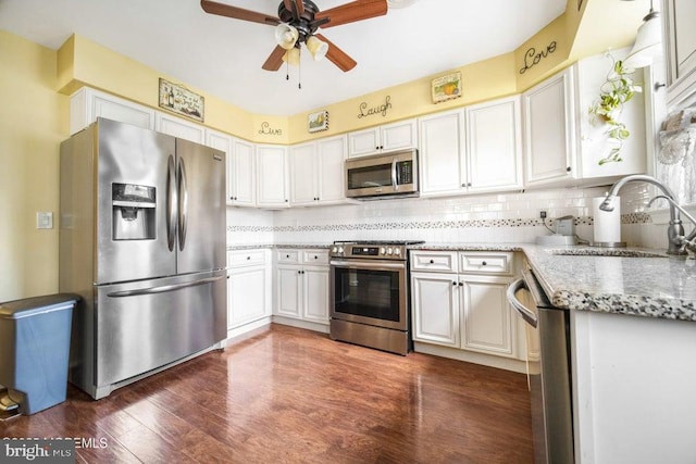 17 Drake St Unit 54A, Whiting, NJ 08759 - kitchen featuring stainless steel appliances, a sink, a ceiling fan, light stone countertops, and dark wood-type flooring