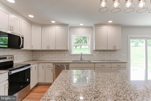 1406 Amosite Rd, Bainbridge, PA 17502 - kitchen featuring appliances with stainless steel finishes, a sink, backsplash, white cabinets, and recessed lighting