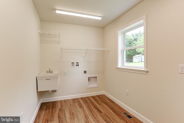 1406 Amosite Rd, Bainbridge, PA 17502 - laundry area featuring light wood-type flooring, hookup for an electric dryer, baseboards, and washer hookup