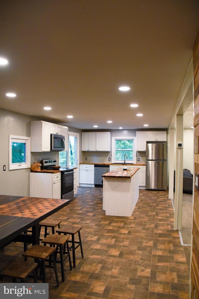 38 Behm Ln, Colora, MD 21917 - kitchen with stainless steel appliances, white cabinetry, a center island, recessed lighting, and a sink