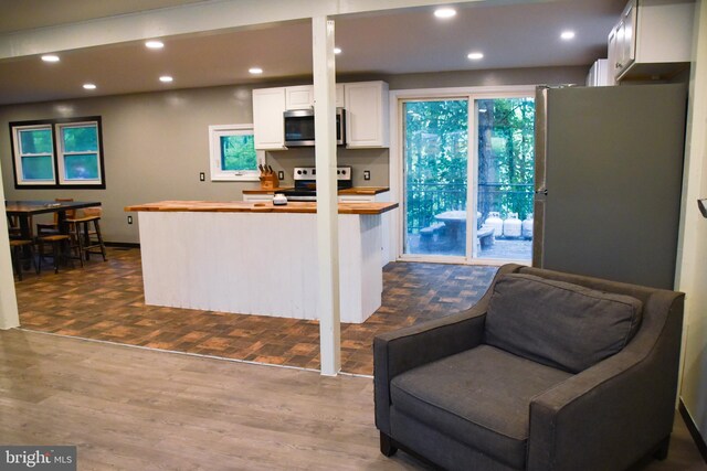 38 Behm Ln, Colora, MD 21917 - kitchen with stainless steel appliances, butcher block countertops, dark wood-style flooring, recessed lighting, and white cabinets