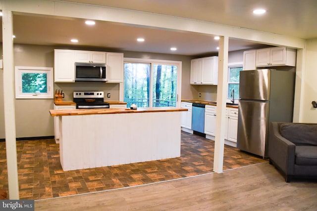 38 Behm Ln, Colora, MD 21917 - kitchen featuring stainless steel appliances, wooden counters, white cabinets, recessed lighting, and a center island