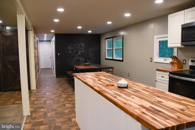 38 Behm Ln, Colora, MD 21917 - kitchen with wooden counters, recessed lighting, electric stove, and white cabinets