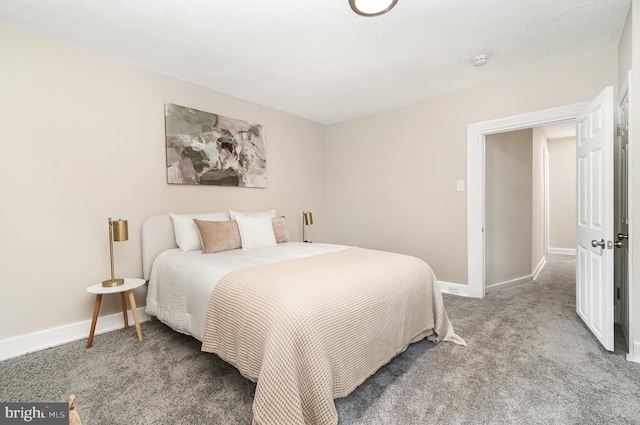 bedroom featuring carpet floors and baseboards
