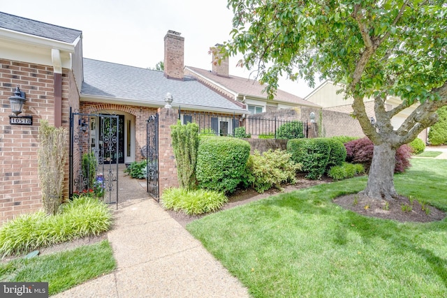 10518 Meadow Bridge Ln, Fairfax, VA 22030 - entrance to property with brick siding, a chimney, a gate, and roof with shingles
