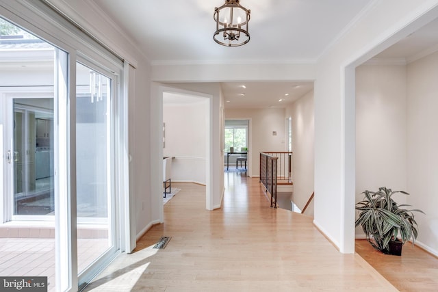 10518 Meadow Bridge Ln, Fairfax, VA 22030 - hallway with an upstairs landing, light wood finished floors, a chandelier, ornamental molding, and baseboards