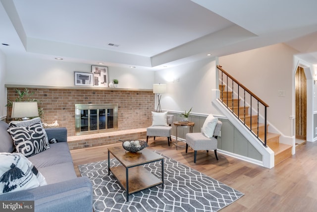 10518 Meadow Bridge Ln, Fairfax, VA 22030 - living area with a raised ceiling, wood finished floors, stairway, a fireplace, and recessed lighting