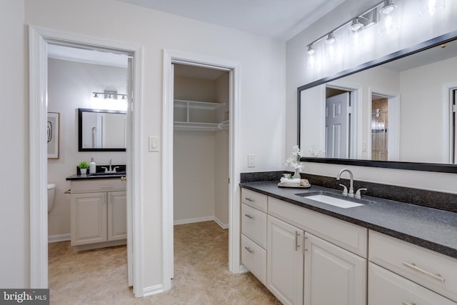 10518 Meadow Bridge Ln, Fairfax, VA 22030 - bathroom featuring vanity, a shower, a spacious closet, and baseboards