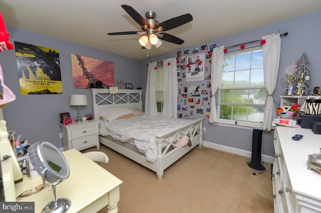 bedroom with light carpet, baseboards, and ceiling fan