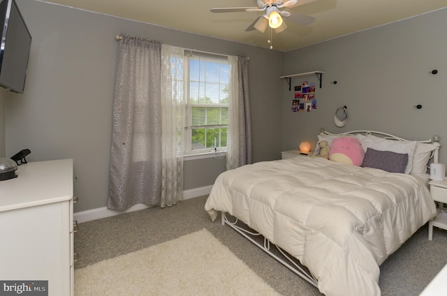 bedroom with light carpet, baseboards, and a ceiling fan
