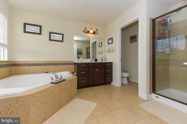 full bathroom featuring a shower stall, a garden tub, vanity, and toilet