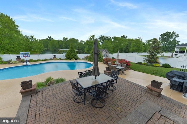 view of pool with a fenced backyard, outdoor dining area, and a patio area