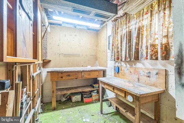 misc room with a workshop area