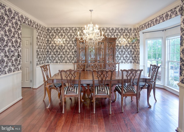 dining area with wallpapered walls, a chandelier, wainscoting, and wood finished floors