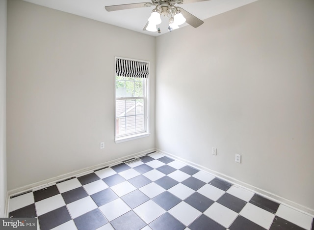 spare room featuring ceiling fan, tile patterned floors, and baseboards