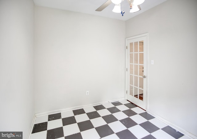 empty room with tile patterned floors and a ceiling fan