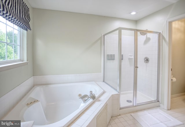 full bath featuring a garden tub, tile patterned flooring, and a stall shower