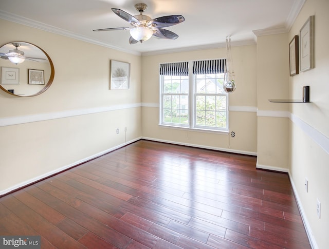 empty room featuring a ceiling fan, hardwood / wood-style flooring, crown molding, and baseboards