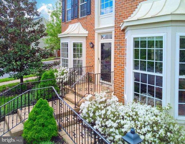 view of exterior entry with brick siding