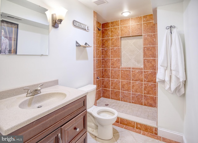 full bathroom with a stall shower, vanity, toilet, and tile patterned floors