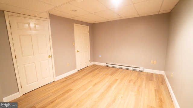 1042 Country Club Rd, Camp Hill, PA 17011 - unfurnished bedroom with a baseboard radiator, a paneled ceiling, and light wood-style floors