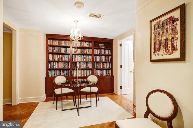 1155 23rd St NW Unit 2E, Washington, DC 20037 - living area featuring a chandelier, built in shelves, and baseboards