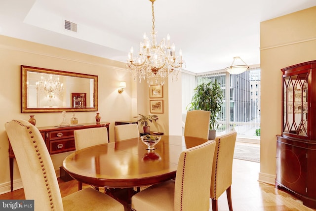 1155 23rd St NW Unit 2E, Washington, DC 20037 - dining room featuring a chandelier, baseboards, and wood finished floors