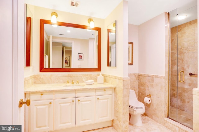 1155 23rd St NW Unit 2E, Washington, DC 20037 - full bathroom with tile walls, vanity, a shower stall, toilet, and a wainscoted wall