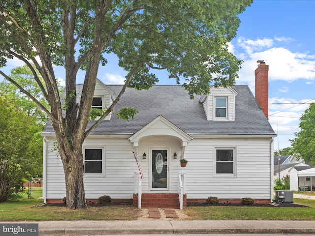304 N Main St, Hebron, MD 21830 - cape cod-style house with cooling unit, a chimney, entry steps, and roof with shingles