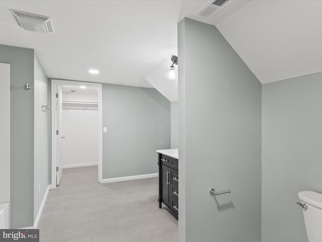 304 N Main St, Hebron, MD 21830 - bathroom featuring vanity, toilet, a spacious closet, recessed lighting, and baseboards