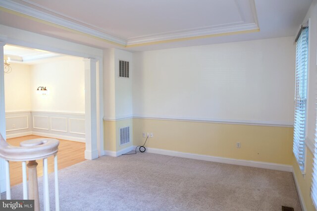 11504 Woodview Ct, Hagerstown, MD 21742 - spare room featuring carpet flooring, ornamental molding, a raised ceiling, and ornate columns