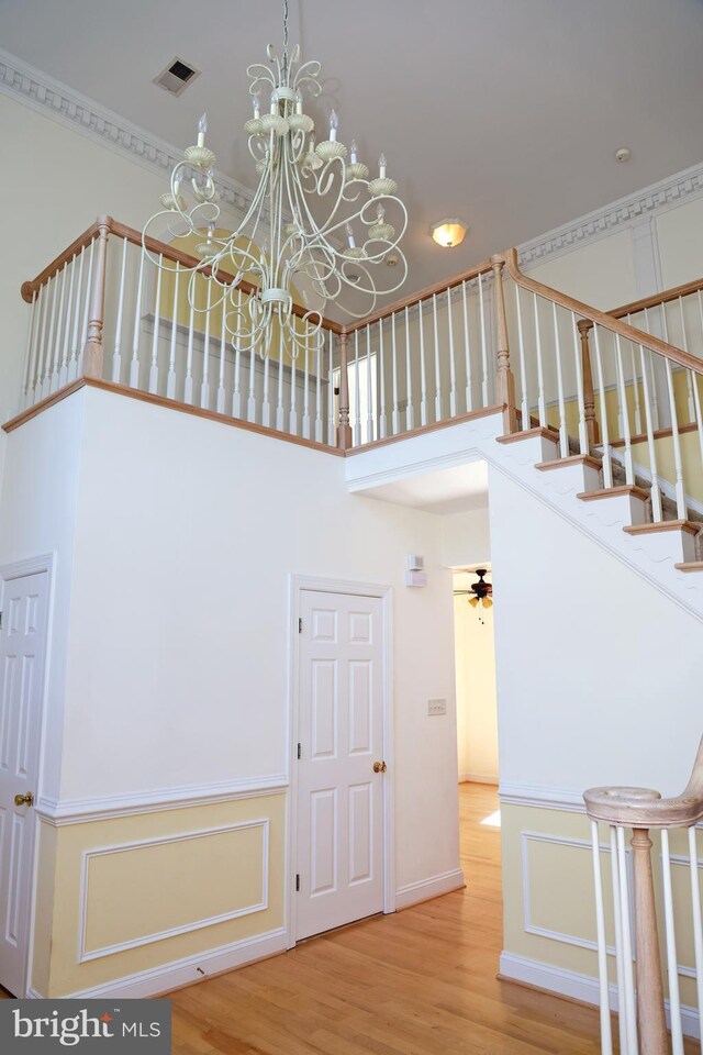 11504 Woodview Ct, Hagerstown, MD 21742 - stairway featuring wood finished floors, a towering ceiling, and a chandelier