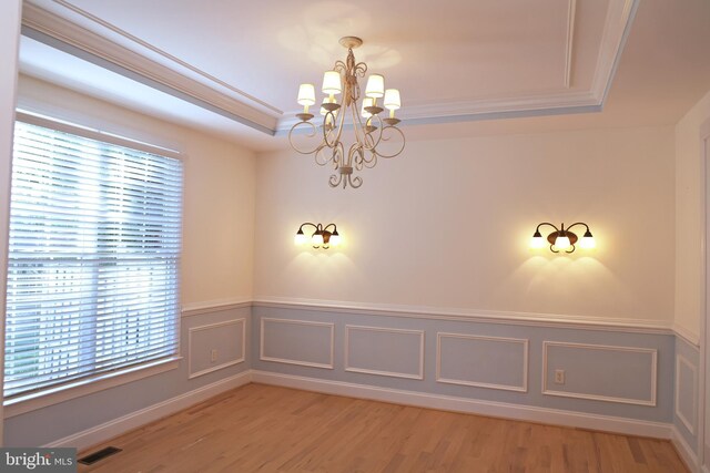 11504 Woodview Ct, Hagerstown, MD 21742 - unfurnished room with a chandelier, plenty of natural light, light wood finished floors, wainscoting, and ornamental molding
