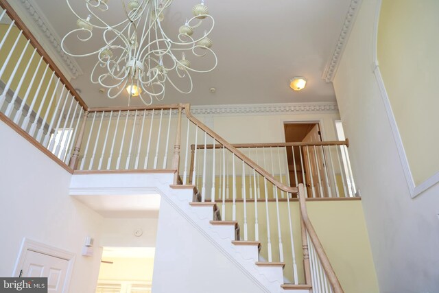 11504 Woodview Ct, Hagerstown, MD 21742 - stairs featuring a chandelier, a towering ceiling, and ornamental molding