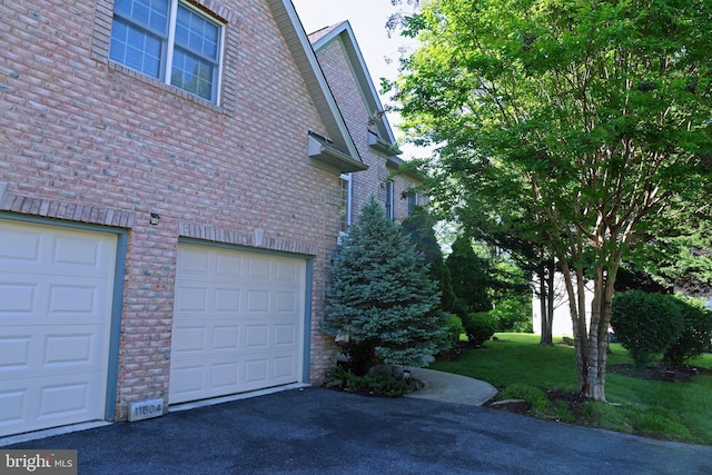 11504 Woodview Ct, Hagerstown, MD 21742 - view of side of home with brick siding, asphalt driveway, and an attached garage