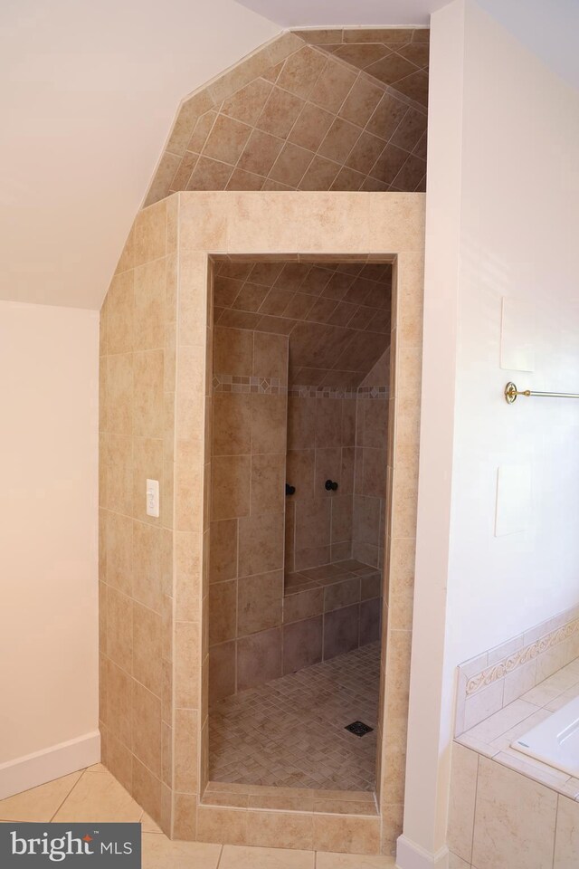 11504 Woodview Ct, Hagerstown, MD 21742 - full bath with a tile shower, lofted ceiling, tile patterned flooring, and a bath