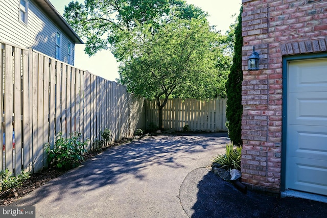 11504 Woodview Ct, Hagerstown, MD 21742 - view of patio featuring asphalt driveway and fence