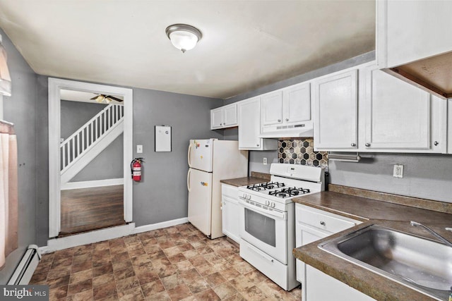 636 Elizabeth St, Beverly, NJ 08010 - kitchen with white appliances, dark countertops, a sink, under cabinet range hood, and a baseboard radiator