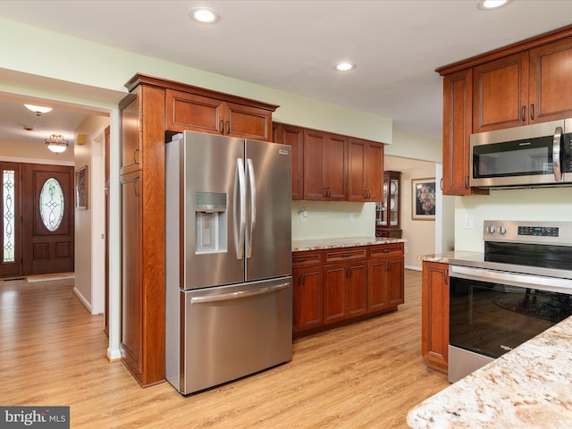 275 Tolstoy Ln, Severna Park, MD 21146 - kitchen with appliances with stainless steel finishes, light wood-type flooring, recessed lighting, and light stone countertops