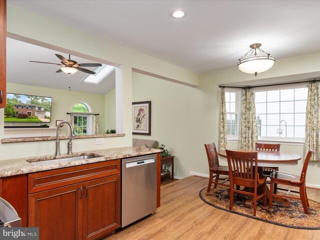 275 Tolstoy Ln, Severna Park, MD 21146 - kitchen featuring dishwasher, a sink, light wood finished floors, a ceiling fan, and light stone countertops