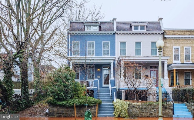 304 12th St NE, Washington, DC 20002 - view of front of property featuring stairs, mansard roof, covered porch, and brick siding