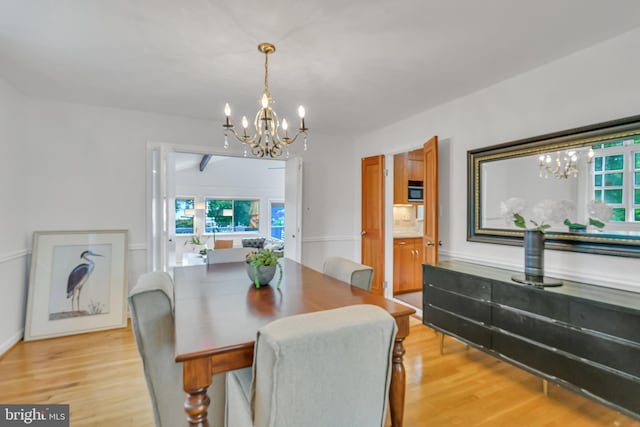 dining space with a chandelier and light wood-type flooring