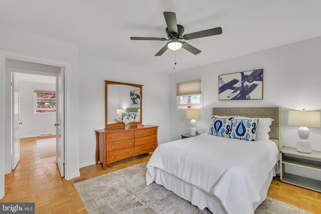 bedroom with ceiling fan and baseboards