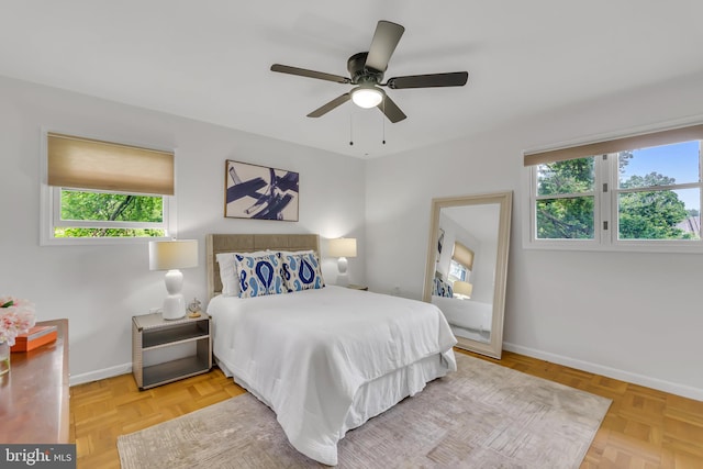 bedroom featuring baseboards and ceiling fan