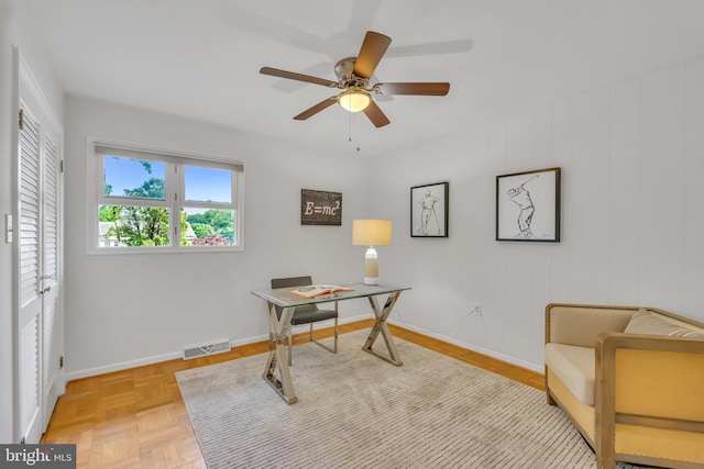 home office with a ceiling fan and baseboards