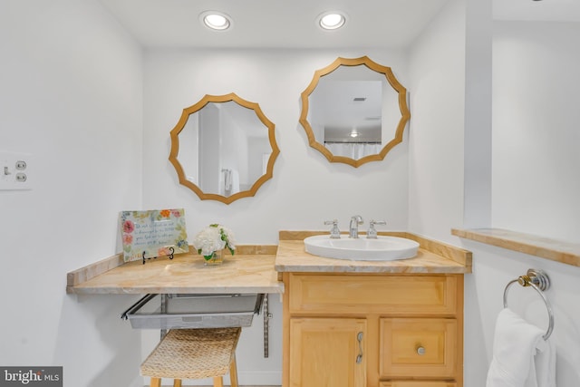 bathroom featuring vanity and recessed lighting