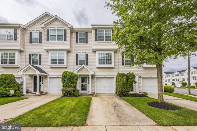 504 Nottingham Pl, Riverside, NJ 08075 - townhome / multi-family property featuring driveway, a garage, and a front lawn