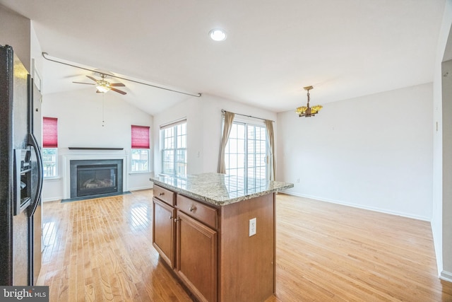 504 Nottingham Pl, Riverside, NJ 08075 - kitchen featuring brown cabinets, ceiling fan, light wood finished floors, a chandelier, and a fireplace with flush hearth