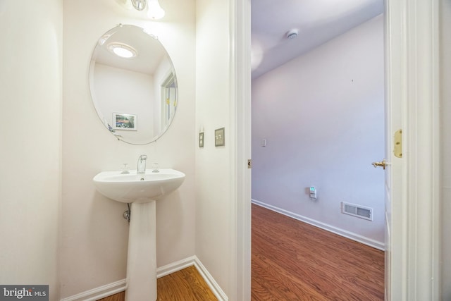 504 Nottingham Pl, Riverside, NJ 08075 - bathroom featuring wood finished floors, a sink, and baseboards